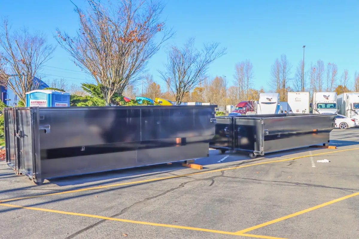 Professional dumpster rental service with roll-off container on residential driveway in Clairton